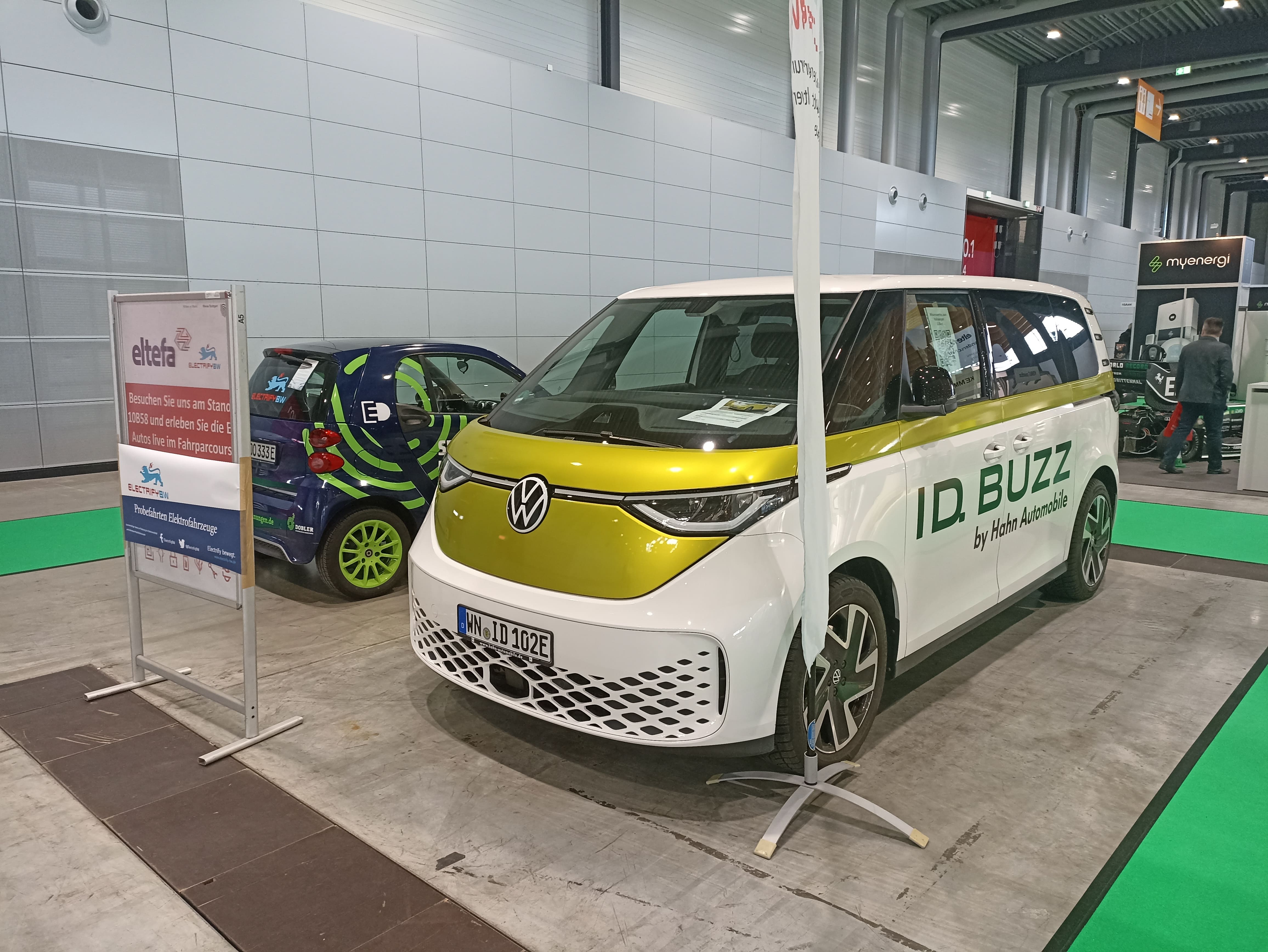 zwei-elektroautos-auf-der-messe-eltefa-2023-smart-vw-id.-buzz